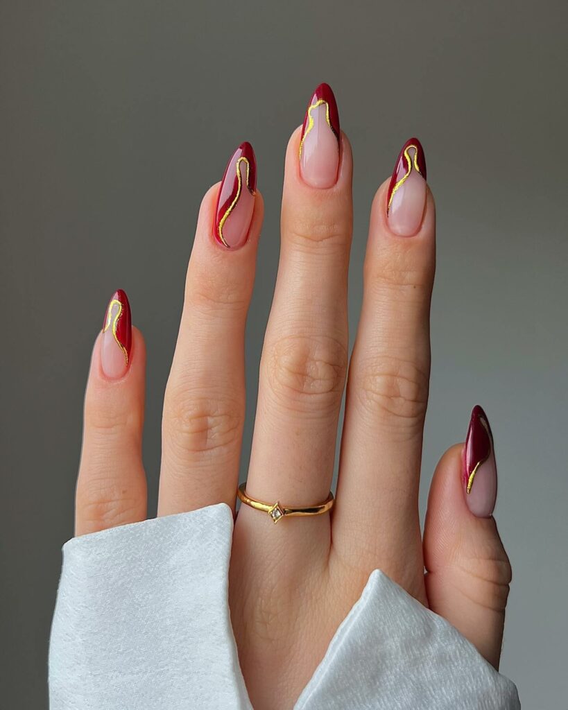 Almond Nails With Burgundy and Gold Tip