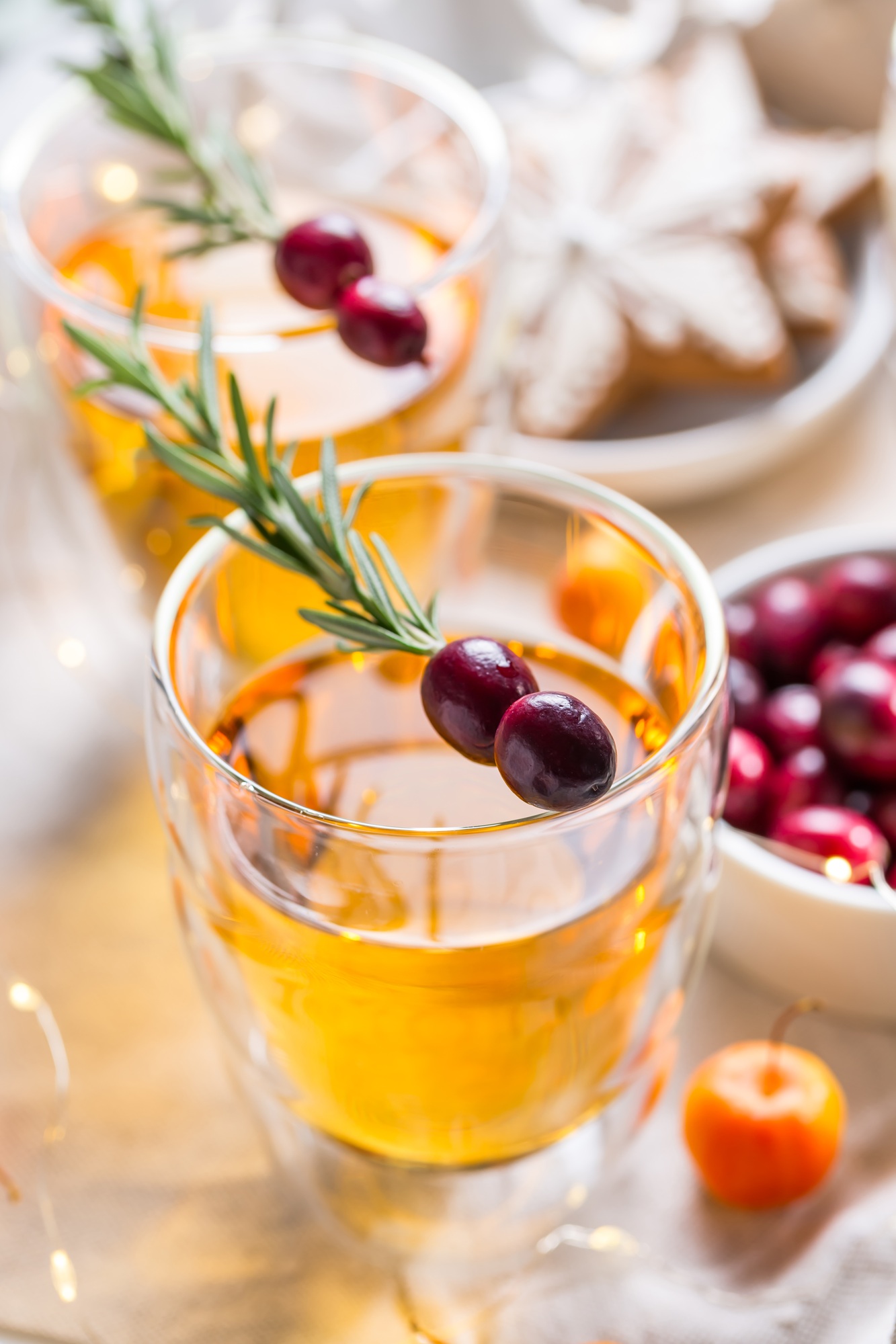 Christmas apple cider cocktail with cranberries and rosemary
