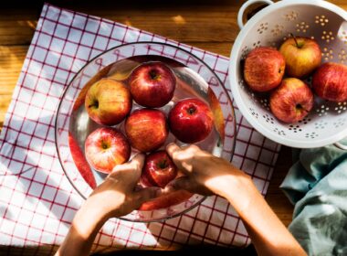 Aerial view of hands washing apples in bowl