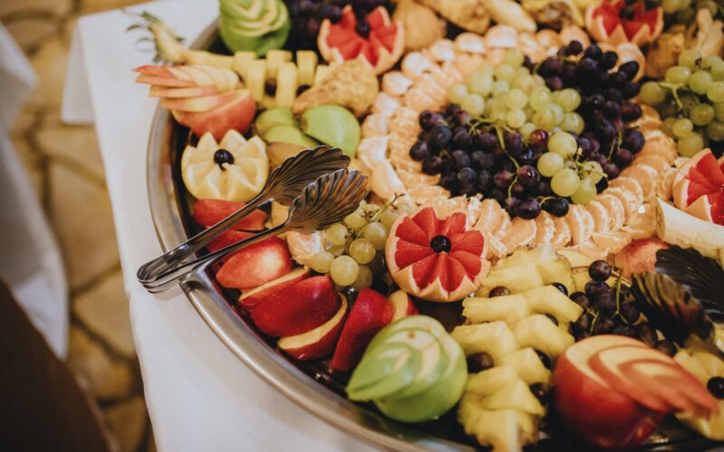 Closeup of beautifully decorated fruits on a large tray, fruit party tray