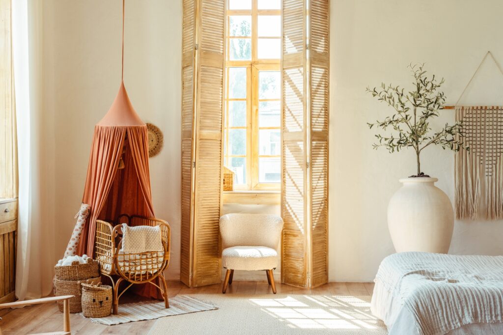 Stylish bright baby room interior with wooden furniture