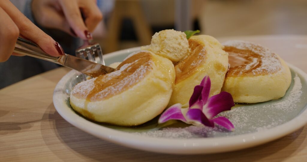 Woman enjoy pancake at coffee shop