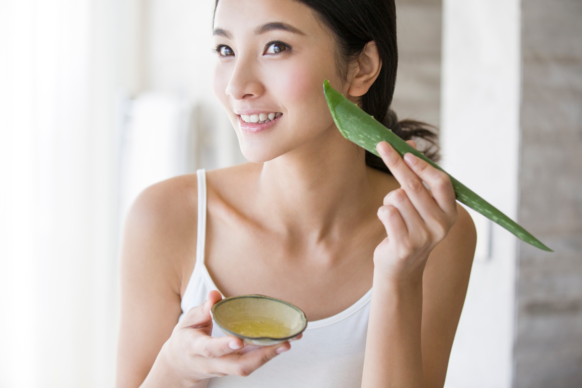 Young woman with natural aloe vera
